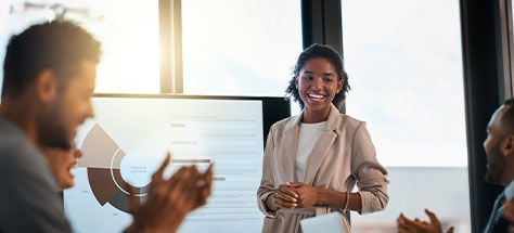 Woman Smiling At A Presentation