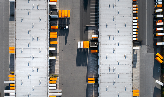A Warehouse Full Of Colourful Orange Trucks